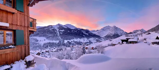 Winter panorama over Hirschegg and the Kleinwalsertal during the Alpine glow
