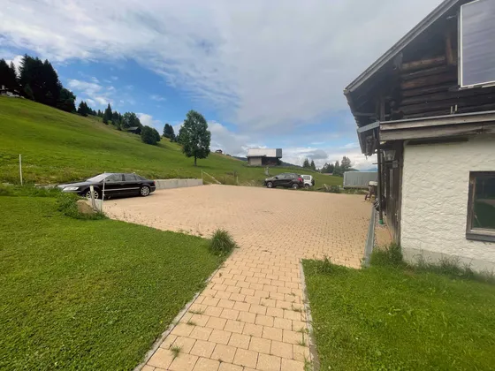 Outdoor cobbled parking area at the Gondamaika holiday house in summer, Hirschegg Kleinwalsertal