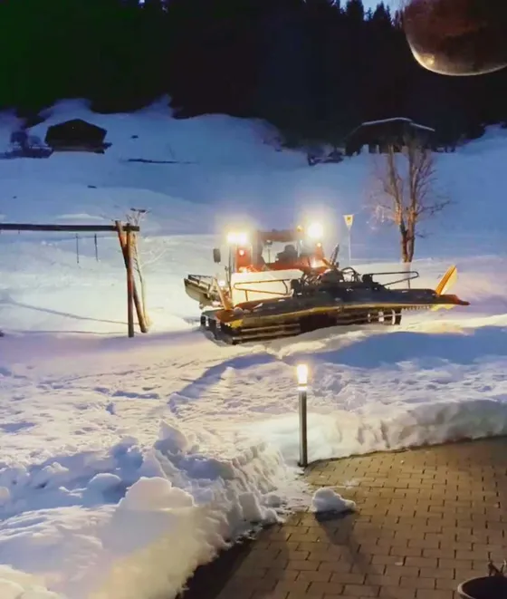 Video: piste-groomer track and snowy garden right by the Gondamaika house on the H8 ski slope, Kleinwalsertal